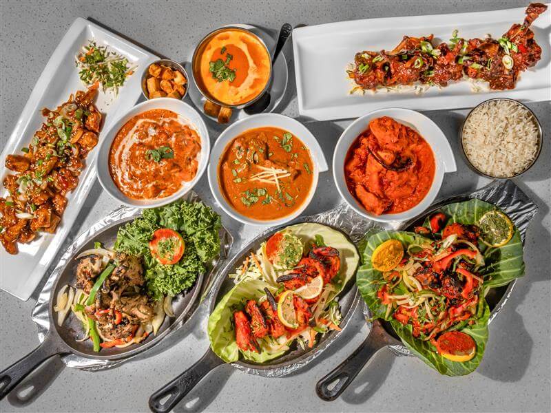 Diverse Indian food platter served on a traditional table